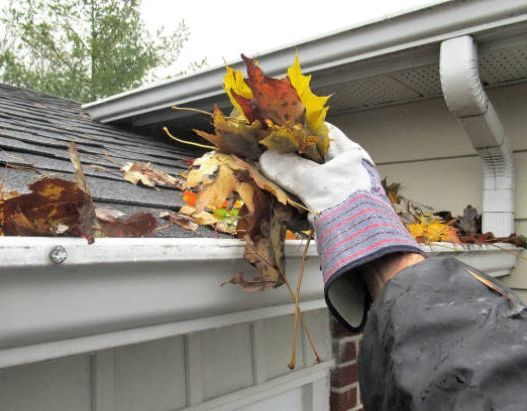 SLR Services technician cleaning residential gutters safely