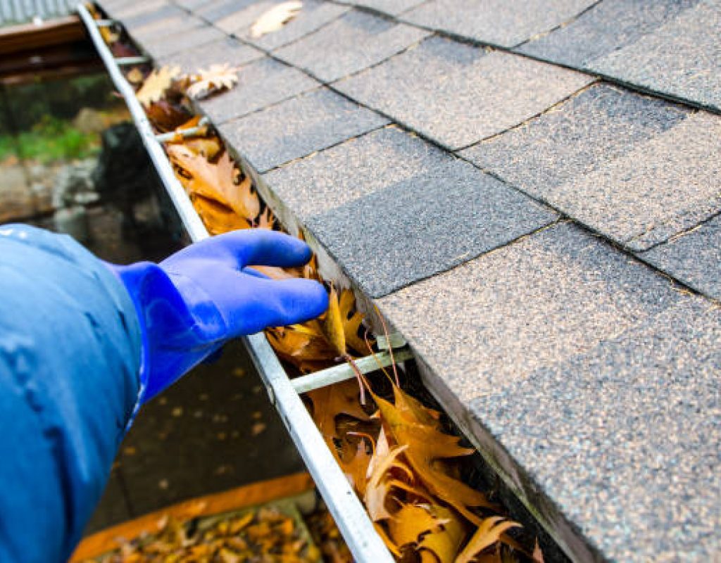 SLR Services maintaining clean gutters for proper drainage